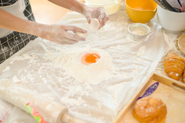 A young beautiful Asian woman is baking in her kitchen  , bakery and coffee shop business