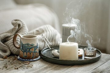 Fototapeta na wymiar Home scandinavian style still life with a cup of tea and candles.