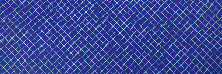 Fototapeta na wymiar Blue mosaic tiles at bottom of transparent pool