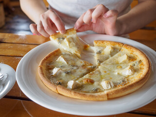 Woman eating pizza and chicken