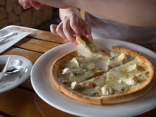 Woman eating pizza and chicken