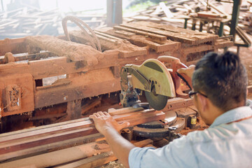 Carpenters using circular saw in workshop