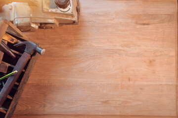 Desk of a carpenter with different tools. Studio shot on a wooden background