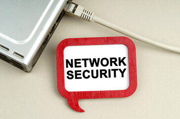 There is a router connected to the network on the table, next to a sign that says - Network security