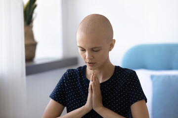 Faithful hopeful happy young hairless after chemotherapy woman praying, begging for healing...