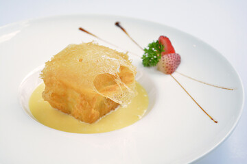 deep fried crispy golden premium durian dessert with yellow sauce in white background asian halal menu