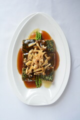 braised handmade spinach vegetable bean curd tofu with mushroom in oyster sauce in white background asian halal menu