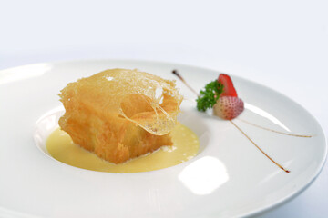 deep fried crispy golden premium durian dessert with yellow sauce in white background asian halal...