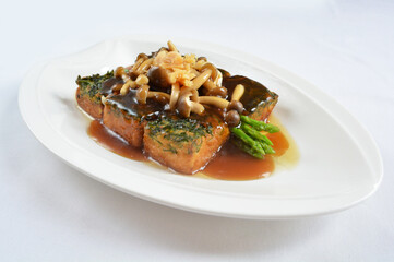 braised handmade spinach vegetable bean curd tofu with mushroom in oyster sauce in white background asian halal menu