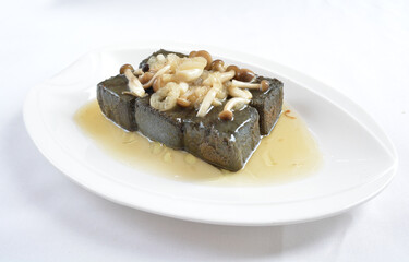 braised home made charcoal bean curd tofu with mushroom in oyster sauce in white background asian halal menu