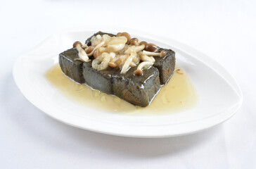 braised home made charcoal bean curd tofu with mushroom in oyster sauce in white background asian halal menu