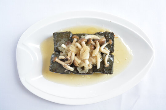 braised home made charcoal bean curd tofu with mushroom in oyster sauce in white background asian halal menu