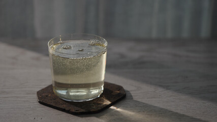 fizzy drink in tumbler glass on oak table