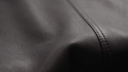 closeup of soft gray brown leather with seam