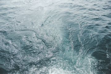 blue emerald water surface with small waves