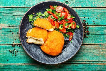 Chicken kiev cutlet with salad