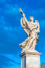 statue of an angel standing on the bridge leading to the Castle Sant'Angelo, Rome