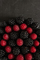 Summer berries. Ripe raspberries and blackberries. Healthy eating. Healthy foods. Juicy berries for dessert. Background for cafe and restaurant. Delicious still life. Seasonal products. Red and black.