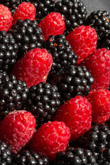 Summer berries. Ripe raspberries and blackberries. Healthy eating. Healthy foods. Juicy berries for dessert. Background for cafe and restaurant. Delicious still life. Seasonal products. Red and black.