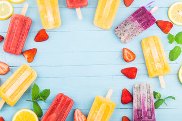 Healthy Whole Fruit Popsicles with Berries Strawberry orange  Dragon fruit  on wooden vintage table