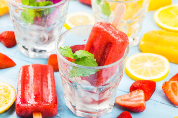 Healthy Whole Fruit Popsicles with Berries Kiwi watermelon cantaloupe on wooden vintage table