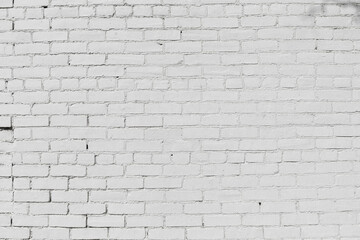 Old brick wall painted white, gaps in the pointing, creative copy space, horizontal aspect