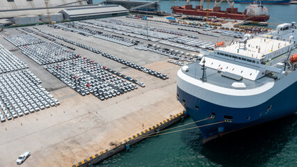 Aerial view a lot of automotive new car for import and export shipping by ship ,  shipping car to...