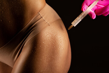lipolytic injections to burn fat on the thighs, hips and body of a woman. Female aesthetic cosmetology in a beauty salon.