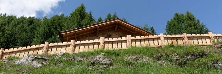 Fototapeta na wymiar New wooden fence on the mountain. Panoramic image