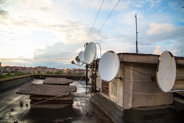 Satellite antennas on the roof of an old multi-storey building