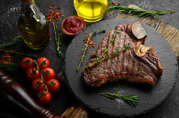 Aged Beef T-Bone steak. Juicy cooked steak with rosemary and spices. Top view. Rustic style. Flat...