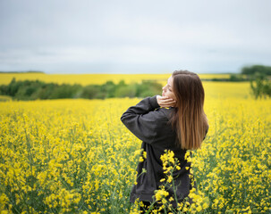 Young girl on yellow rapeseed field