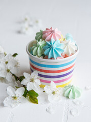 Small colorful meringues in the  paper bowl