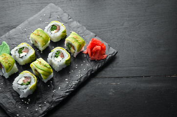 Sushi roll with avocado, salmon and onion. Free space for your text. Japanese Traditional Cuisine. Top view. Rustic style.