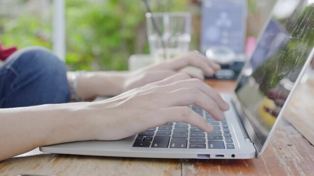Close up hand key to find information online laptop sits in garden studying online. Video Webinar. remote video conference at home. business online shopping. Work at home. register online	