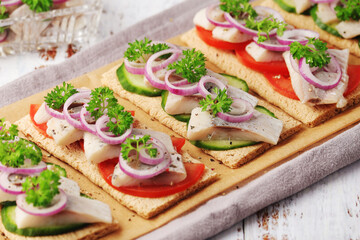 Sandwiches with herring and vegetables