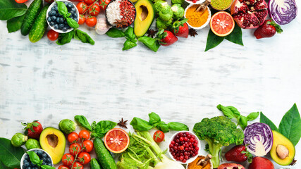 Diet food concept: fresh vegetables and fruits on white wooden background. Free space for your text.