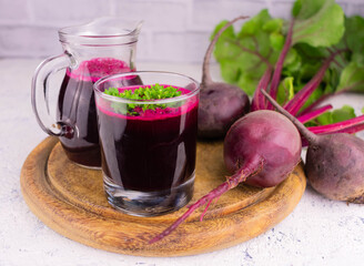 Beet juice in a glass and a decanter in the background. Detox drinks concept.
