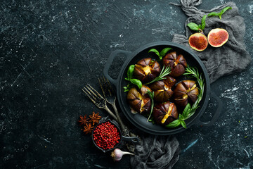 Baked figs with brie cheese and basil in a pan. Free space for your text. Top view.