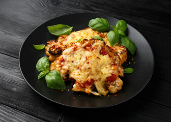 Baked Cauliflower steak with marinara sauce and cheese on plate. Healthy vegetarian food