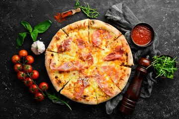 Delicious pizza with cheese and prosciutto. Top view. Food delivery.