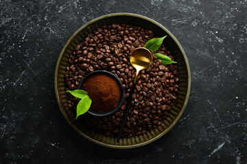 Set of ground coffee and coffee beans on a black stone background. Top view. Free space for text.