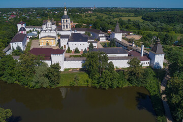 Fototapeta na wymiar Above the ancient Nativity of the Theotokos Svyato-Pafnutyev Borovsky monastery on a sunny July day. Kaluga region, Russia