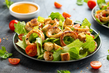 Grilled squid or calamari and prawns salad with garlic croutons and cherry tomatoes
