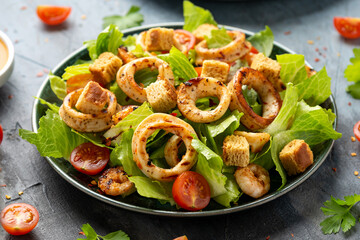 Grilled squid or calamari and prawns salad with garlic croutons and cherry tomatoes