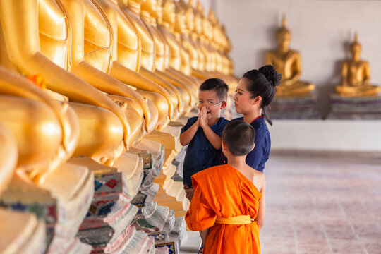 Mother and son praying respect buddha statue in Wat Phutthai Sawan Temple, Ayutthaya