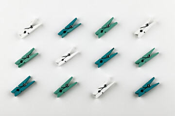 clothes pins pattern on white background. multi-colored clothespins isolated