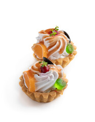 shortcrust pastry with whipped cream and toffees decorated with marmalade isolated on white