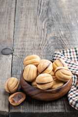 traditional russian walnut tea-cakes in wooden bowl on rustic table