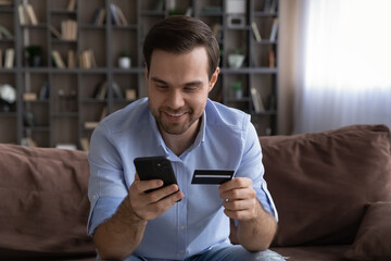 Easy paying. Excited man ecommerce service client make purchase online book ticket using mobile...